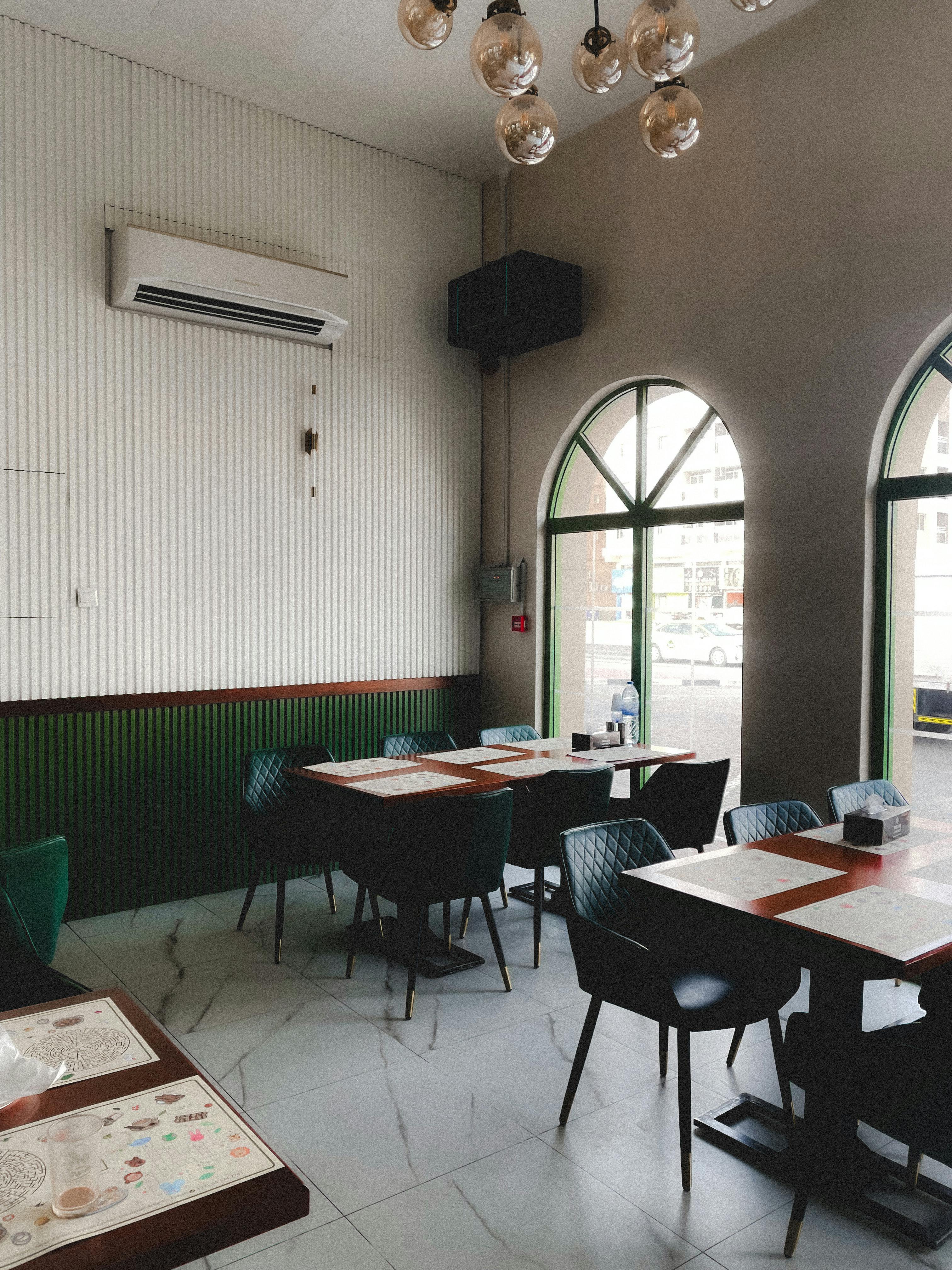A stylish and inviting empty cafe interior with modern decor in Ajman, United Arab Emirates.