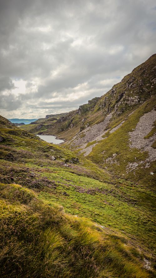 Free Breathtaking view of lush green hills and a lake in Croaghane, Ireland. Stock Photo