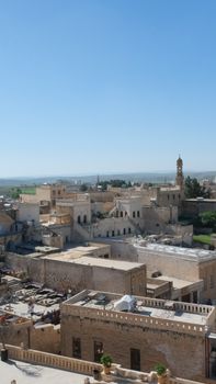 Explore the historic architecture of Midyat, Mardin, Türkiye under a clear blue sky.