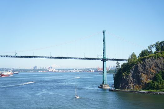Scenic view of Lions Gate Bridge spanning the Burrard Inlet on a clear summer day.