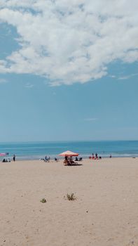 Relaxing scene of Bartın beach with sun umbrellas and people enjoying the summer day.