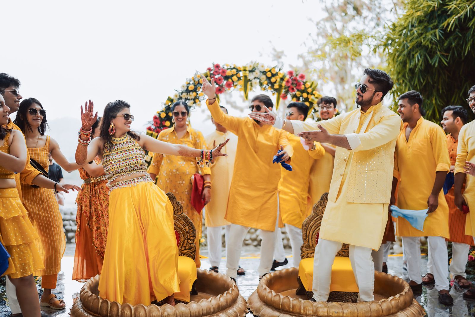 Guests joyfully dancing together at an Indian wedding celebration outdoors