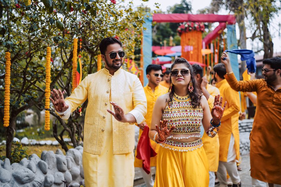 A colourful Indian celebration with guests in traditional attire dancing together
