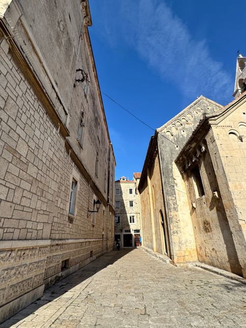 Free Charming stone alley in an old European town under a clear blue sky. Stock Photo