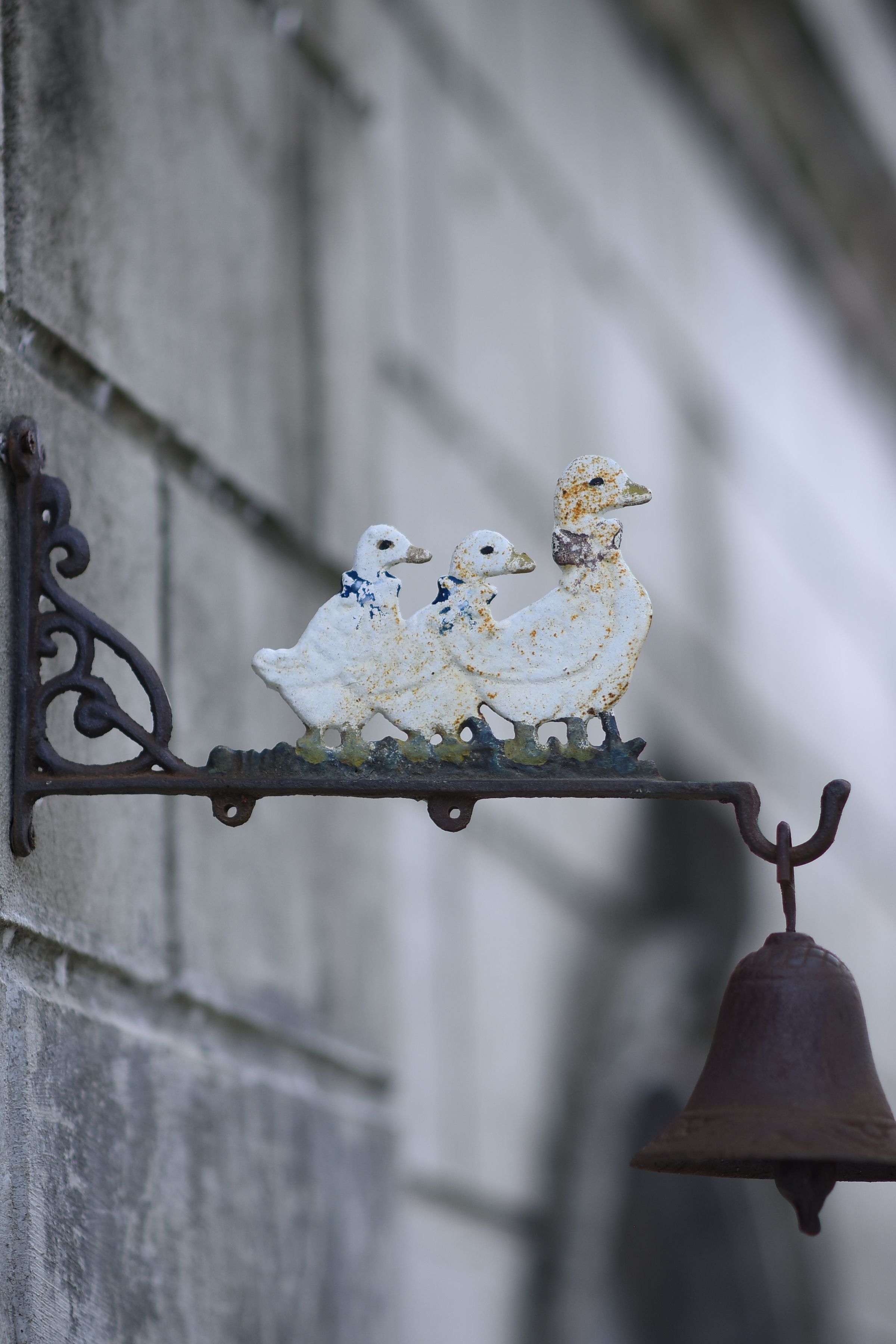 Rustic Decorative Bell with Duck Design on Wall · Free Stock Photo