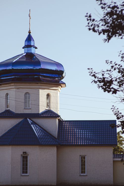 Free A serene view of the blue domed roof of an Orthodox church under a clear sky. Stock Photo