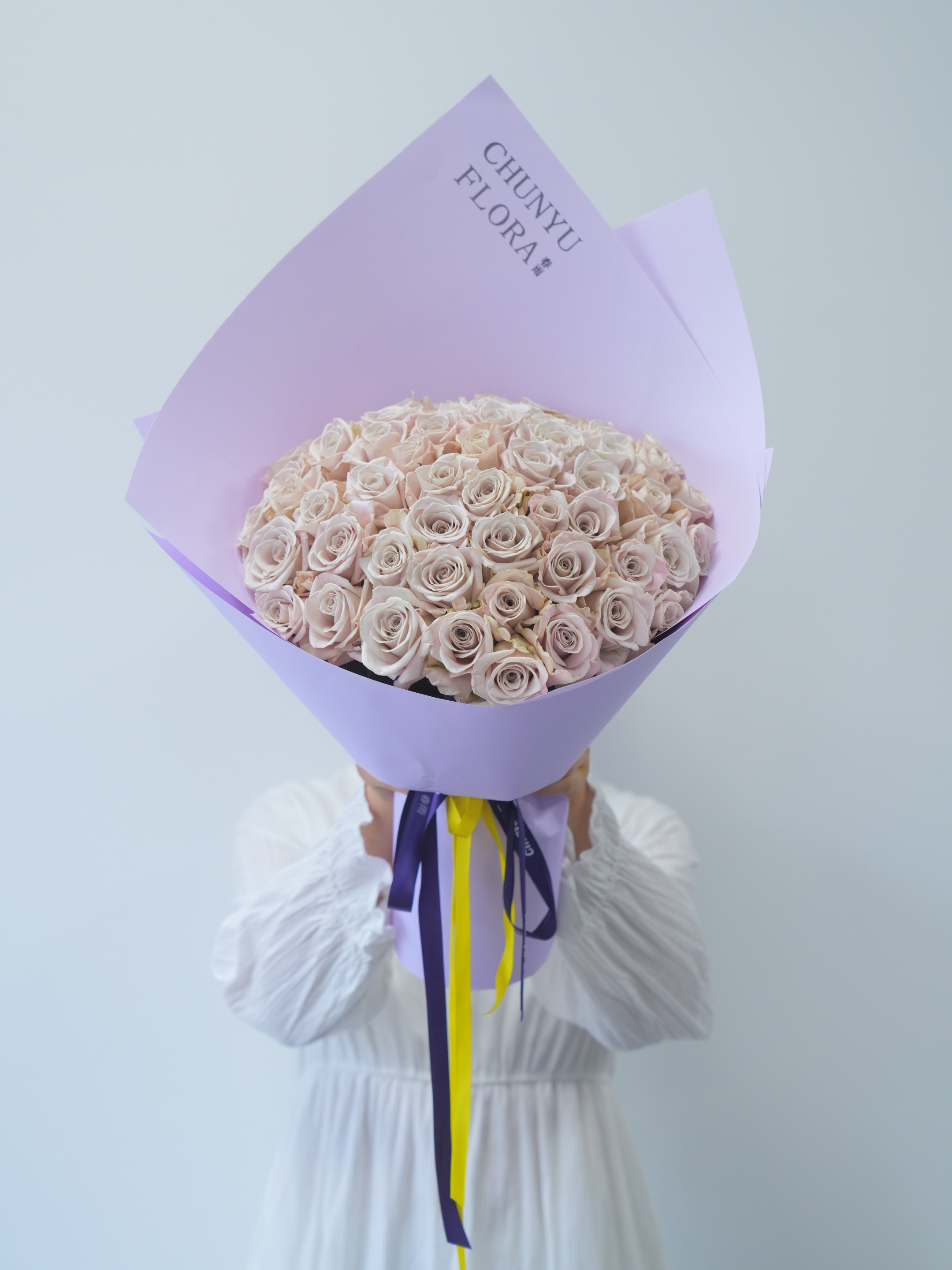 Elegant Bouquet of Roses with Lavender Wrapping · Free Stock Photo