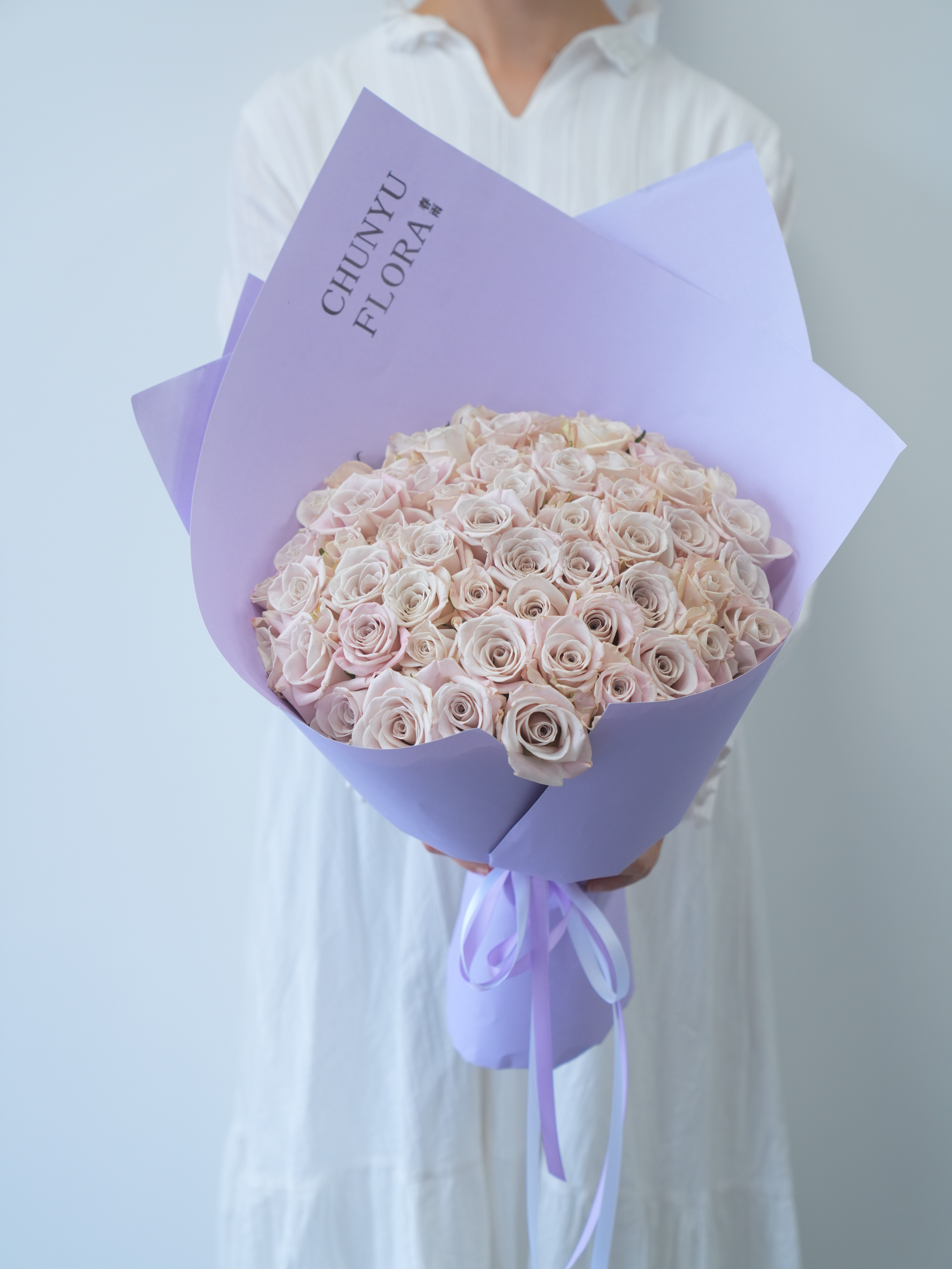 Elegant Bouquet of Pink Roses in Lavender Wrap · Free Stock Photo