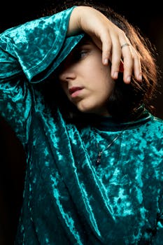 Velvet fashion portrait, woman posing with hand on forehead, studio photography. by Luka Van der Cruyssen