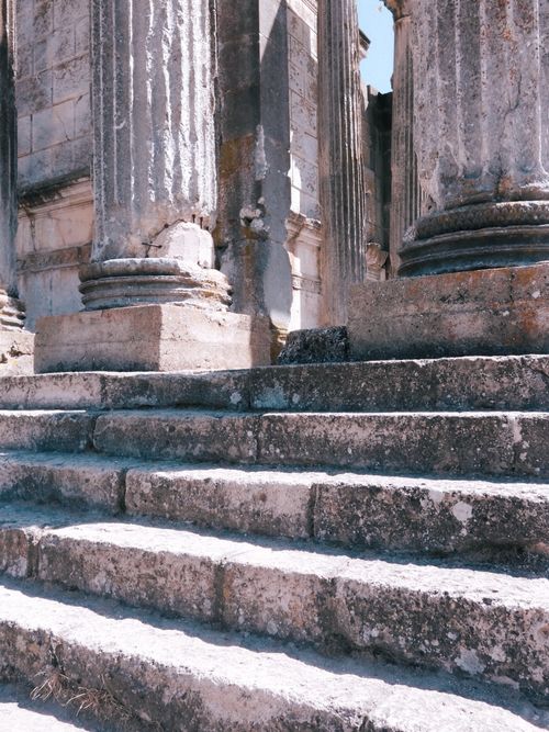 Free Weathered stone steps leading to classical pillars in ancient ruins. Stock Photo