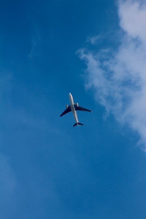 White Airplane Flying over White Clouds · Free Stock Photo