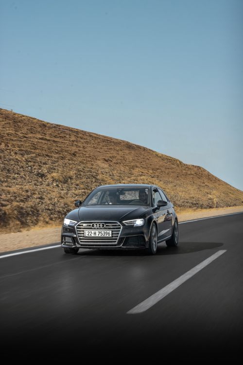 Free Black car driving on an open desert road under clear skies. Stock Photo