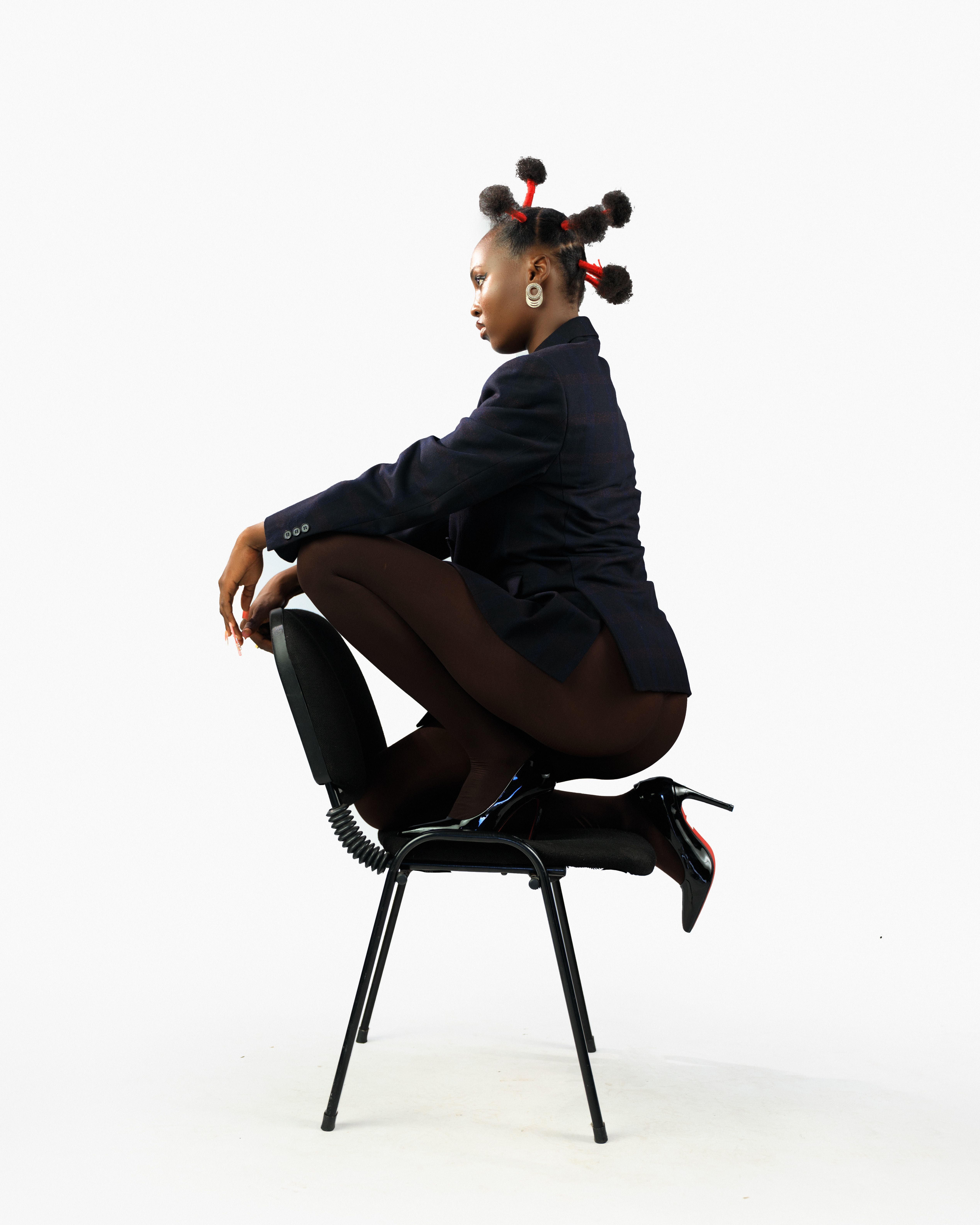 Fashion Model in Artistic Pose on Chair · Free Stock Photo
