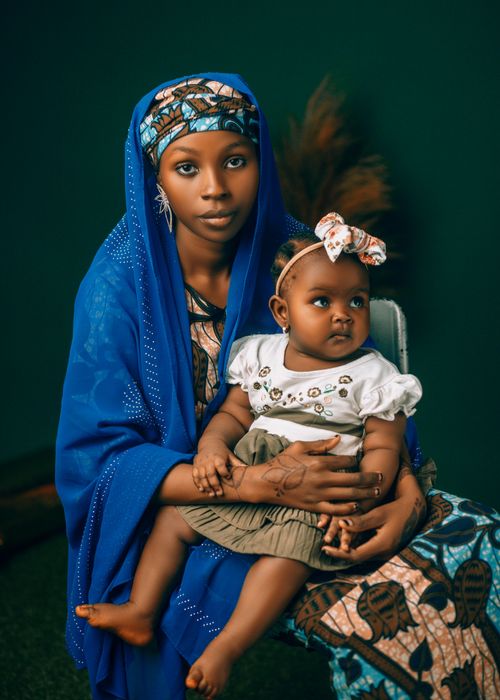Free A mother and her baby in vibrant Nigerian clothing expressing cultural heritage. Stock Photo