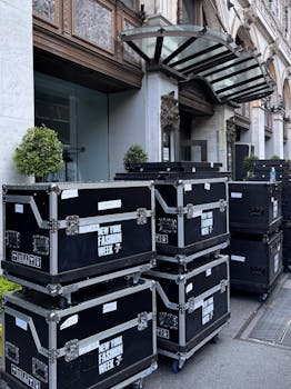 Stacked equipment cases on display outside a building for New York Fashion Week.
