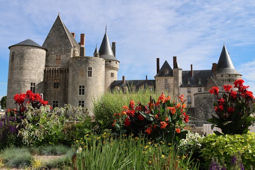 Beautiful view of Sully-sur-Loire Castle with colorful summer flowers in the foreground.
