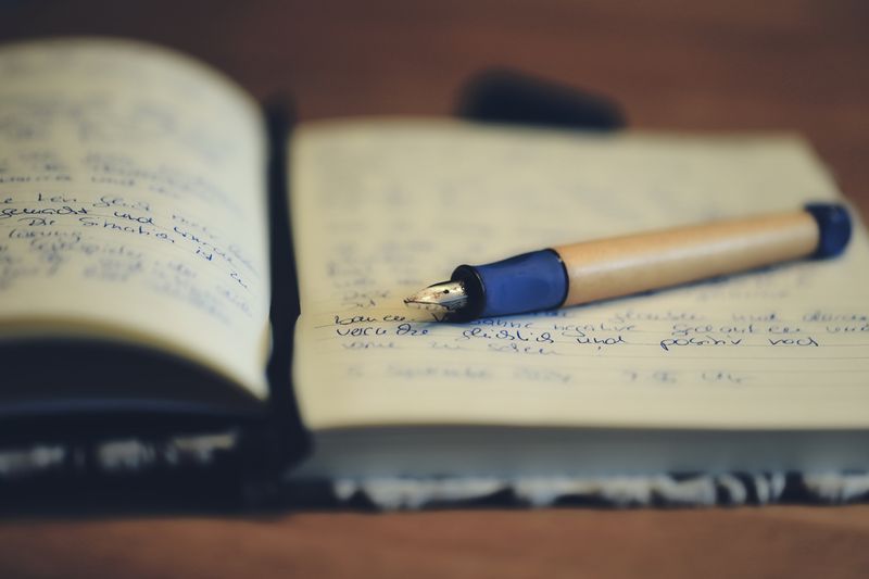 Fountain pen resting on an open notebook — photo by Christina & Peter on Pexels