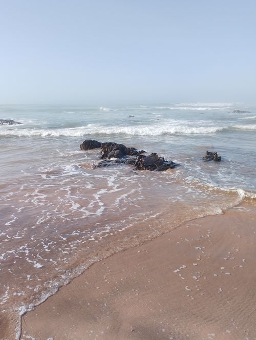 Free Calm ocean waves washing over rocks on a serene beach in Casablanca, Morocco. Stock Photo