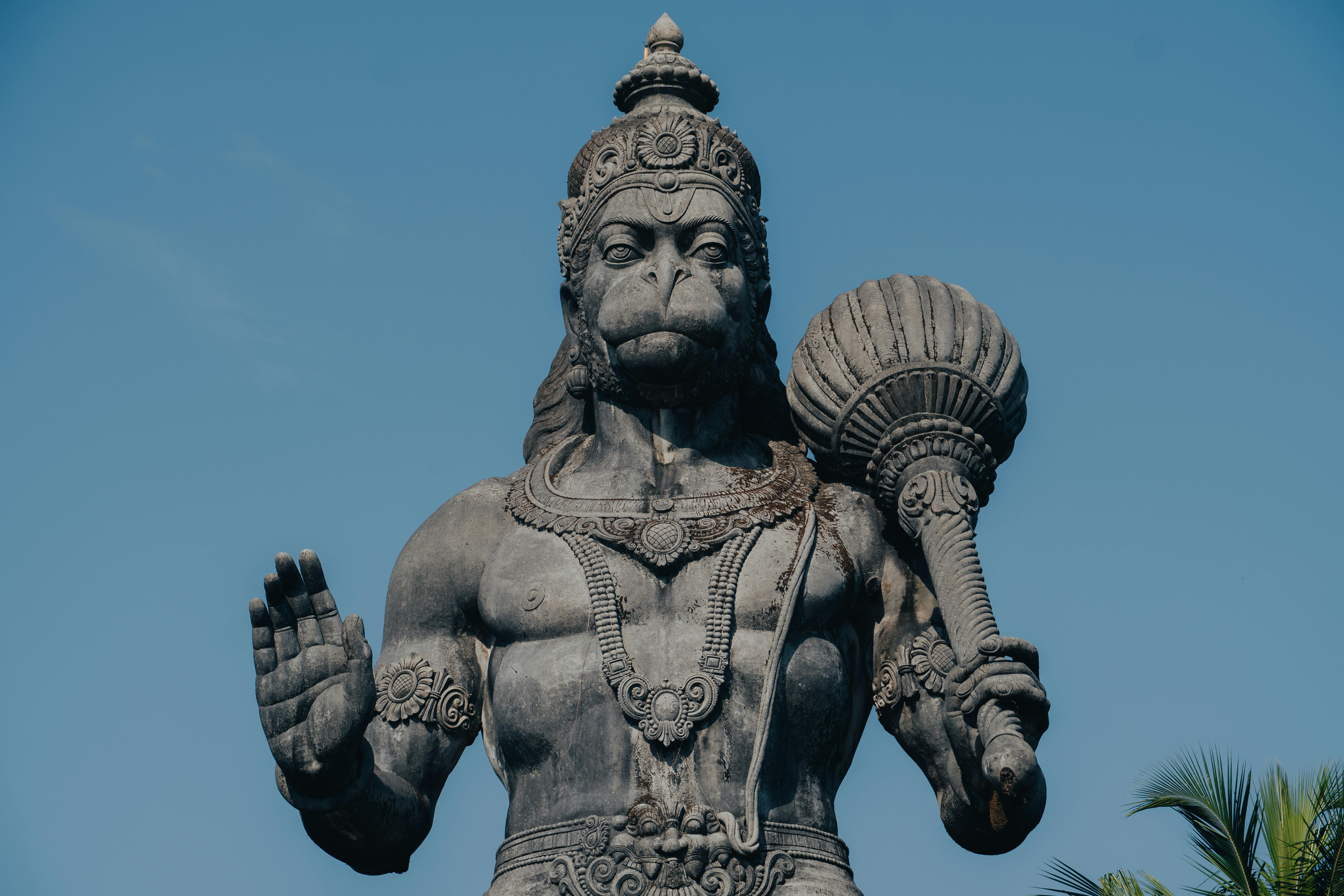 Close-up of an intricate Hanuman statue in Bengaluru under a clear blue sky.
