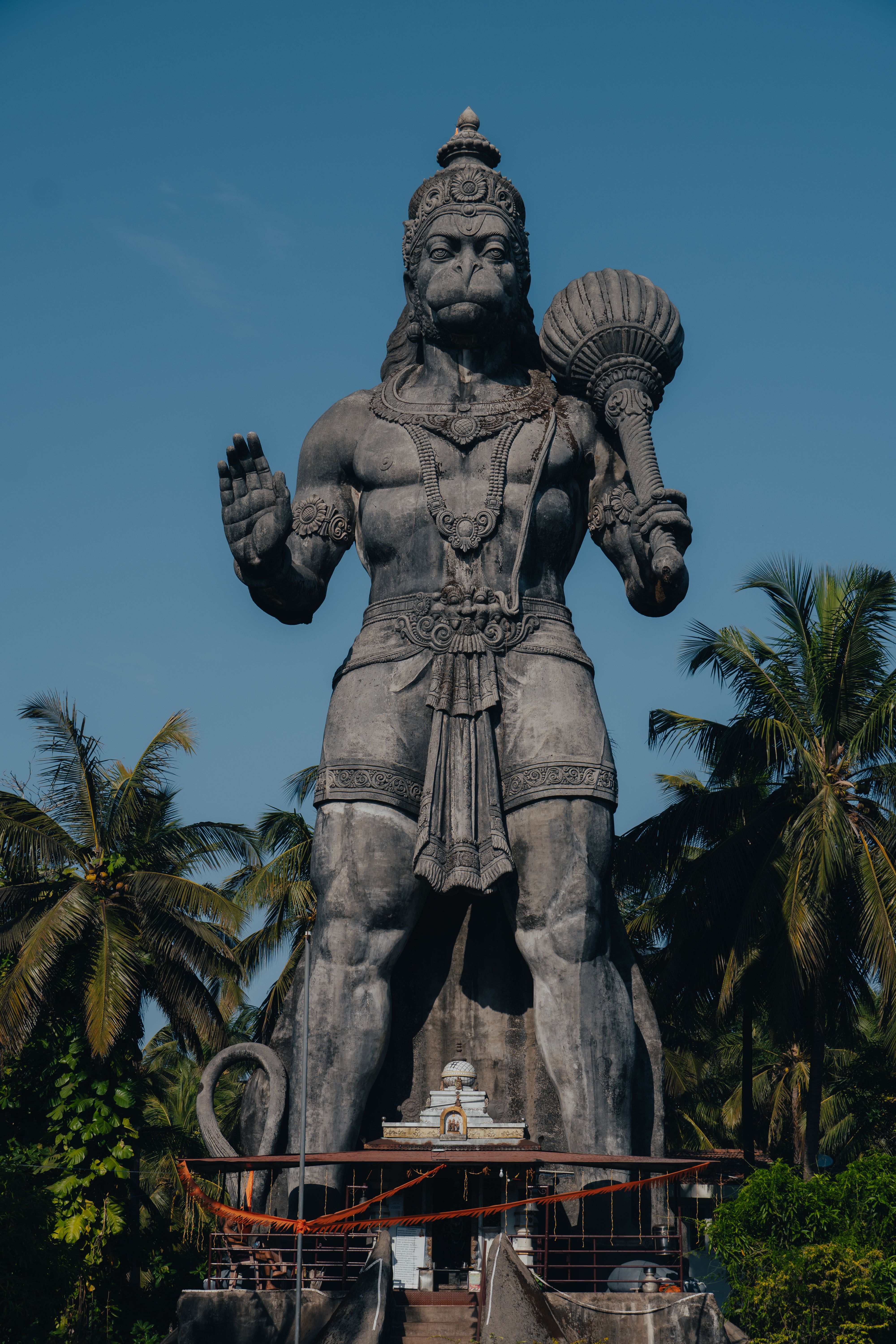 A towering Hanuman statue, symbolizing strength and devotion, set against a clear blue sky in Bengaluru, India.