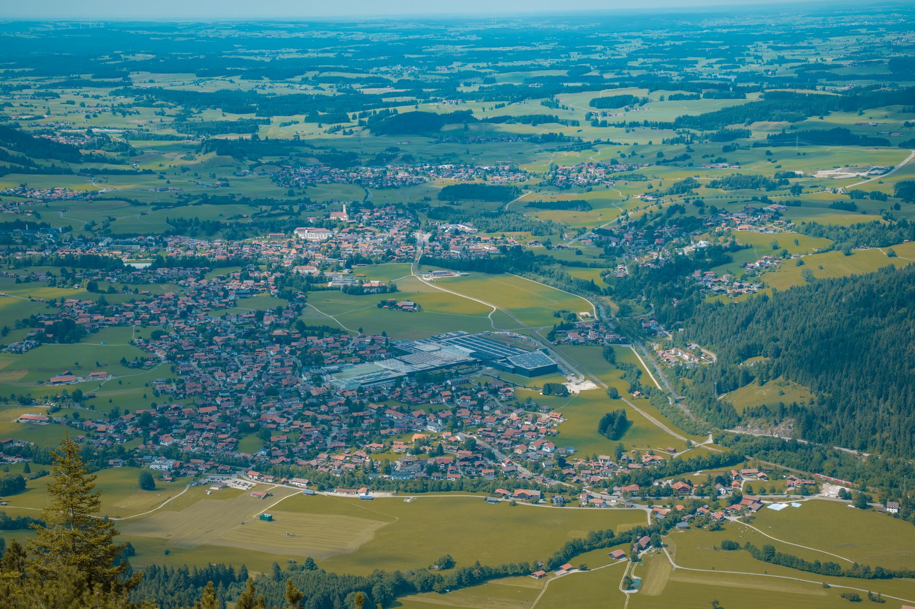 Stunning aerial photograph of a Bavarian village surrounded by lush summer greenery.