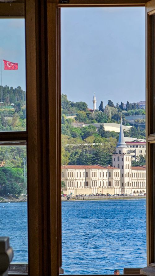 Free Captivating view of Istanbul's architecture and Bosphorus through a window frame on a sunny day. Stock Photo