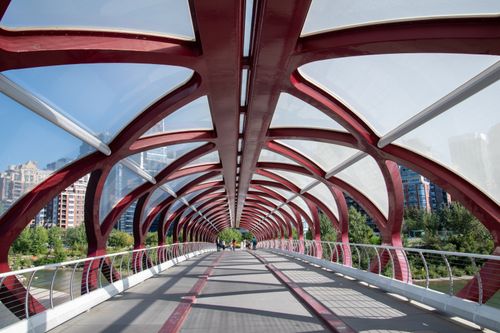 Free View of the iconic red Peace Bridge in Calgary, Alberta on a sunny day. Stock Photo