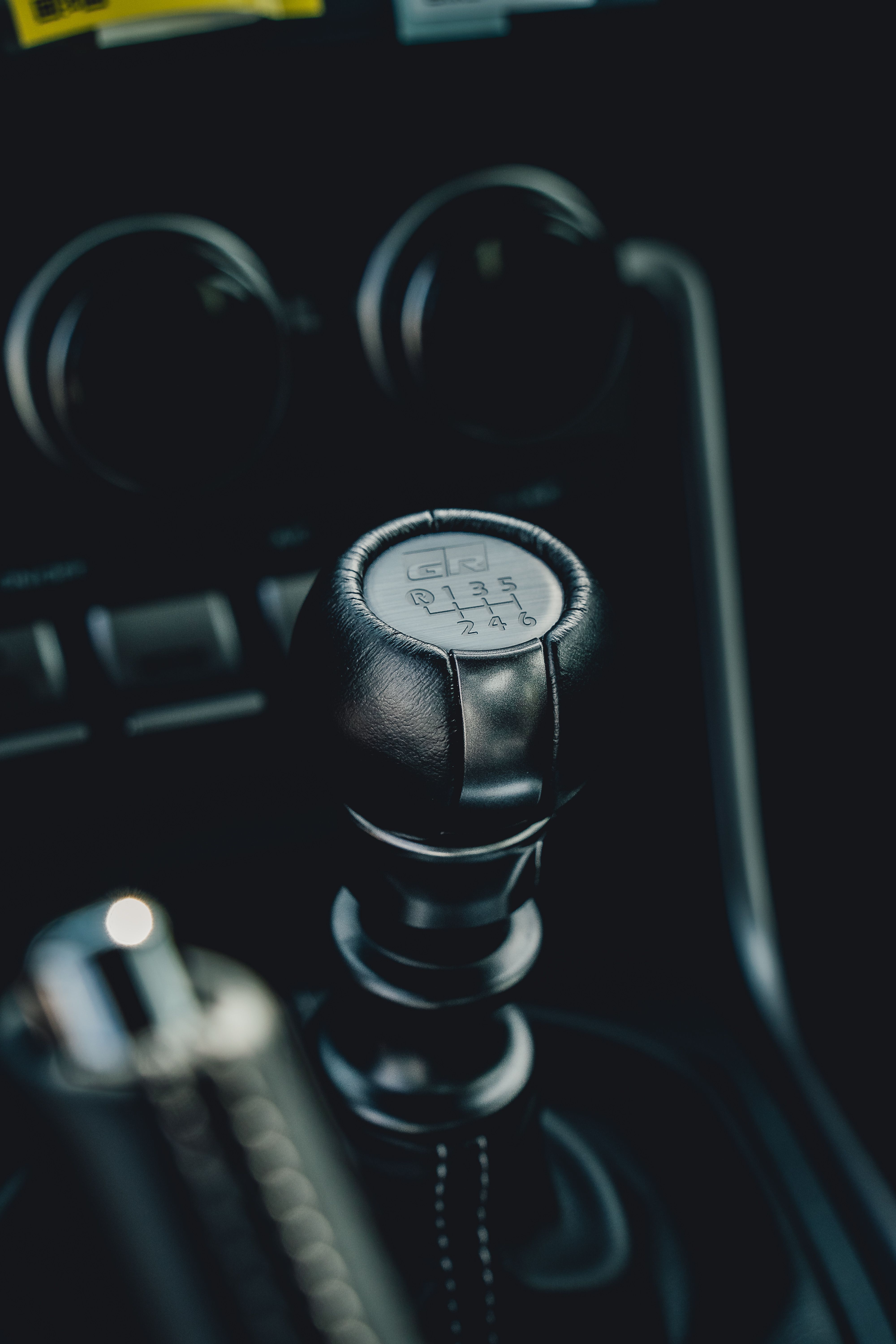 A close-up of a manual car gear shift lever