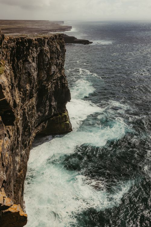 Free Stunning view of the rugged Cliffs of Moher meeting the Atlantic Ocean. Stock Photo