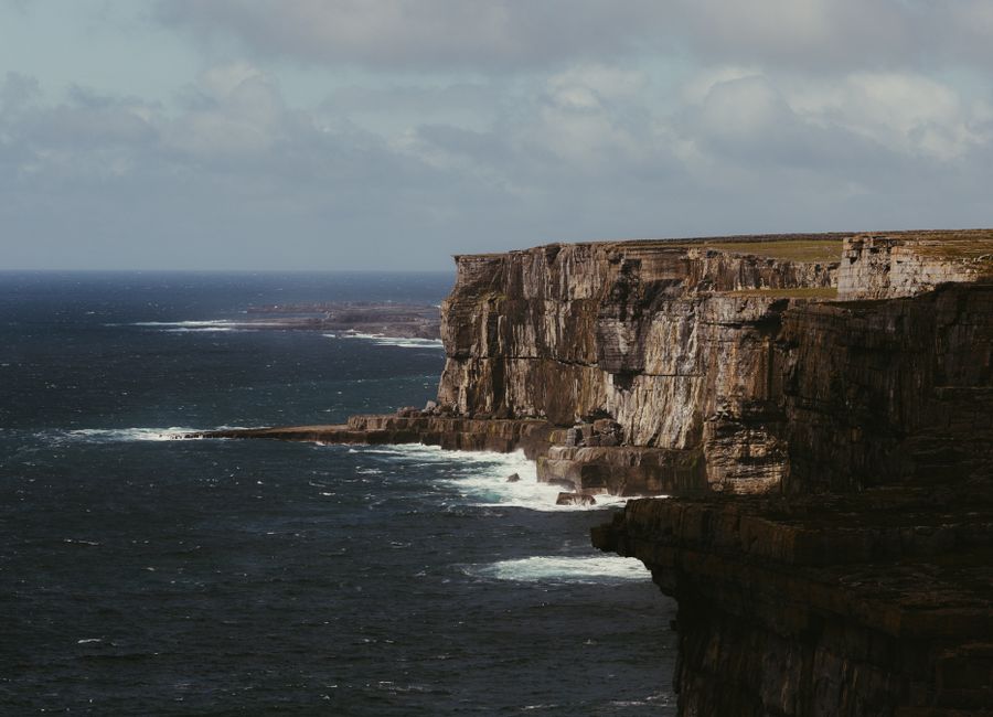 Majestic cliffs meet the ocean in County Clare, Ireland, showcasing nature's grandeur.