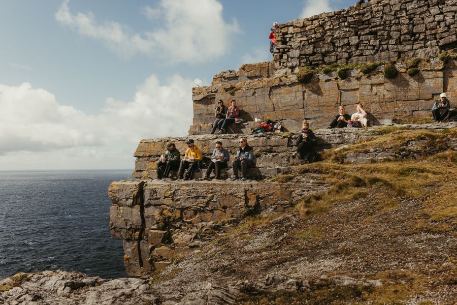 Tourists enjoying the views from the cliffs of the Aran Islands in County Clare, Ireland