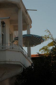 A serene balcony with a parasol on Heybeliada, Istanbul, capturing the peaceful ambiance of the island.
