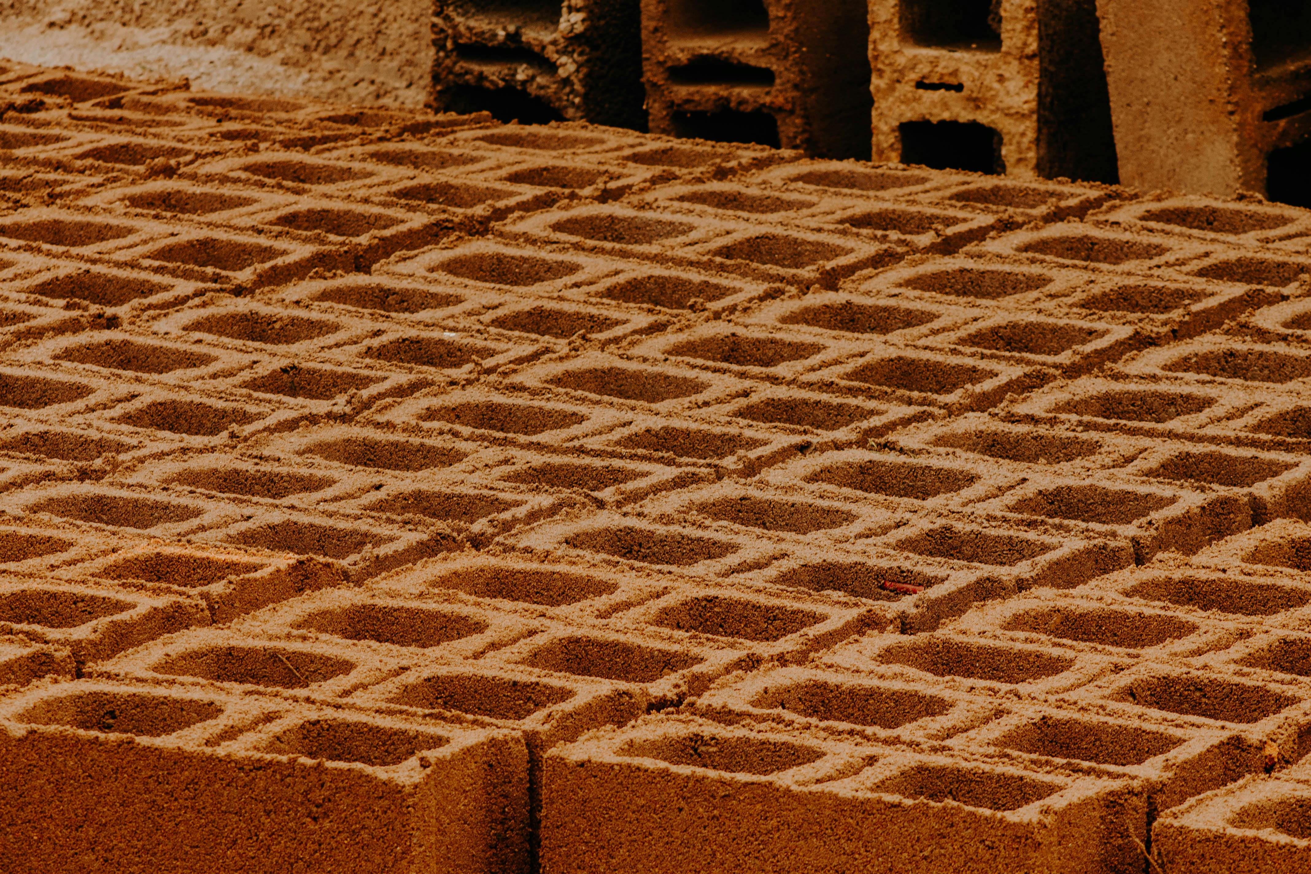 Close-up view of patterned concrete blocks in a construction site.