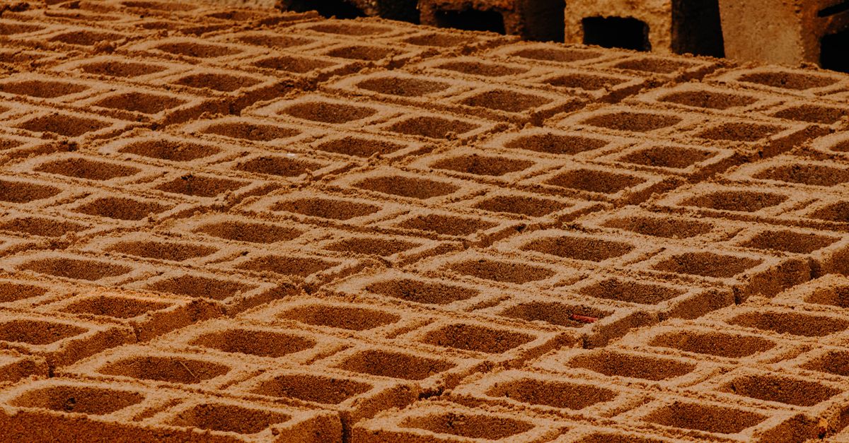 Close-up view of patterned concrete blocks in a construction site.