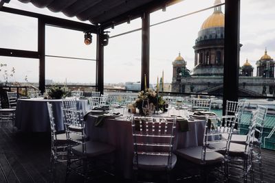 Rooftop terrace laid with round tables for dinner — Dmitry Ovsyannikov on Pexels