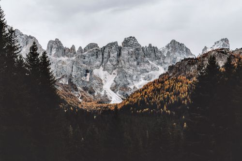 Free Stunning view of Dolomite mountains with autumn foliage under a cloudy sky. Stock Photo