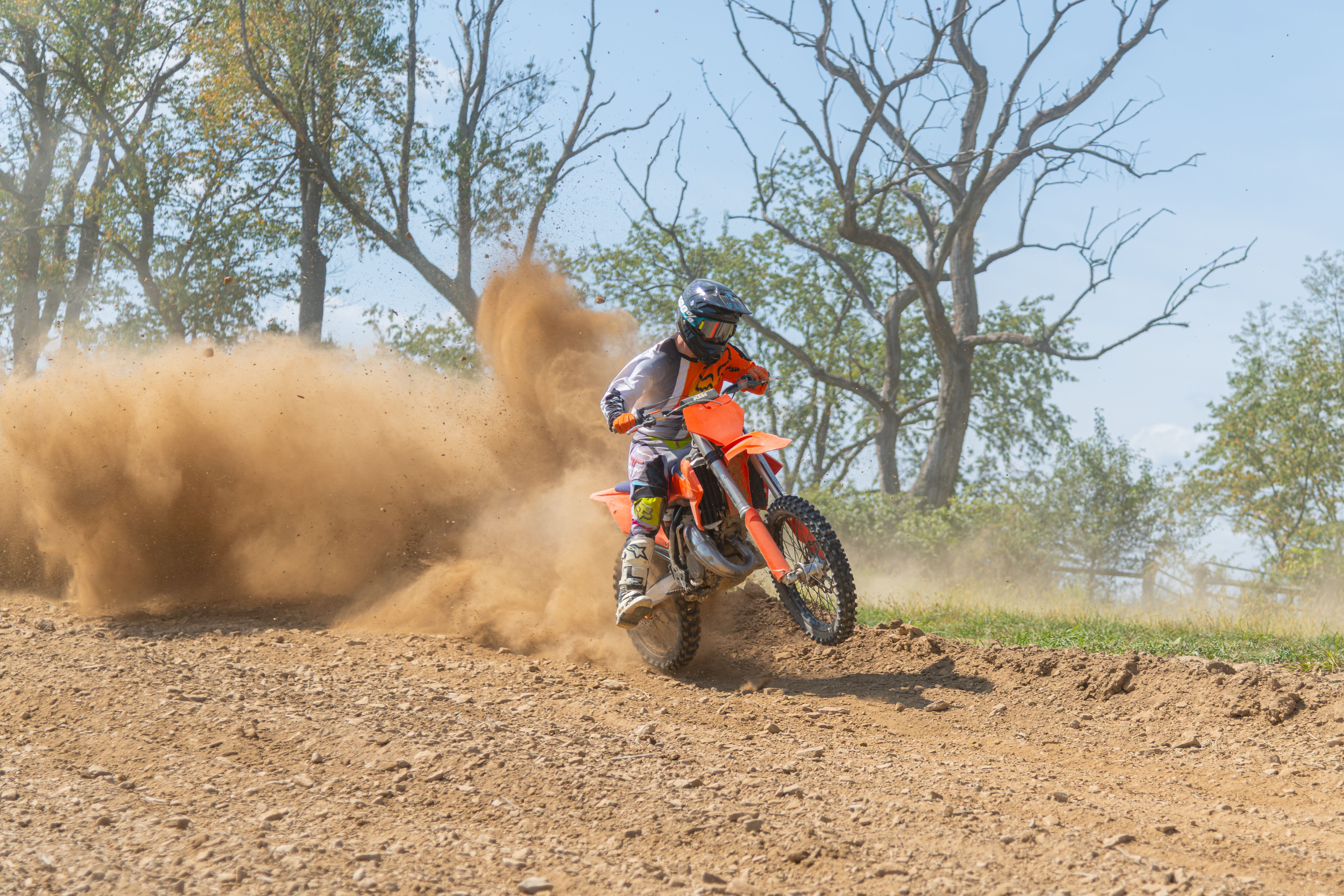 Dynamic Motocross Action on Dusty Track · Free Stock Photo