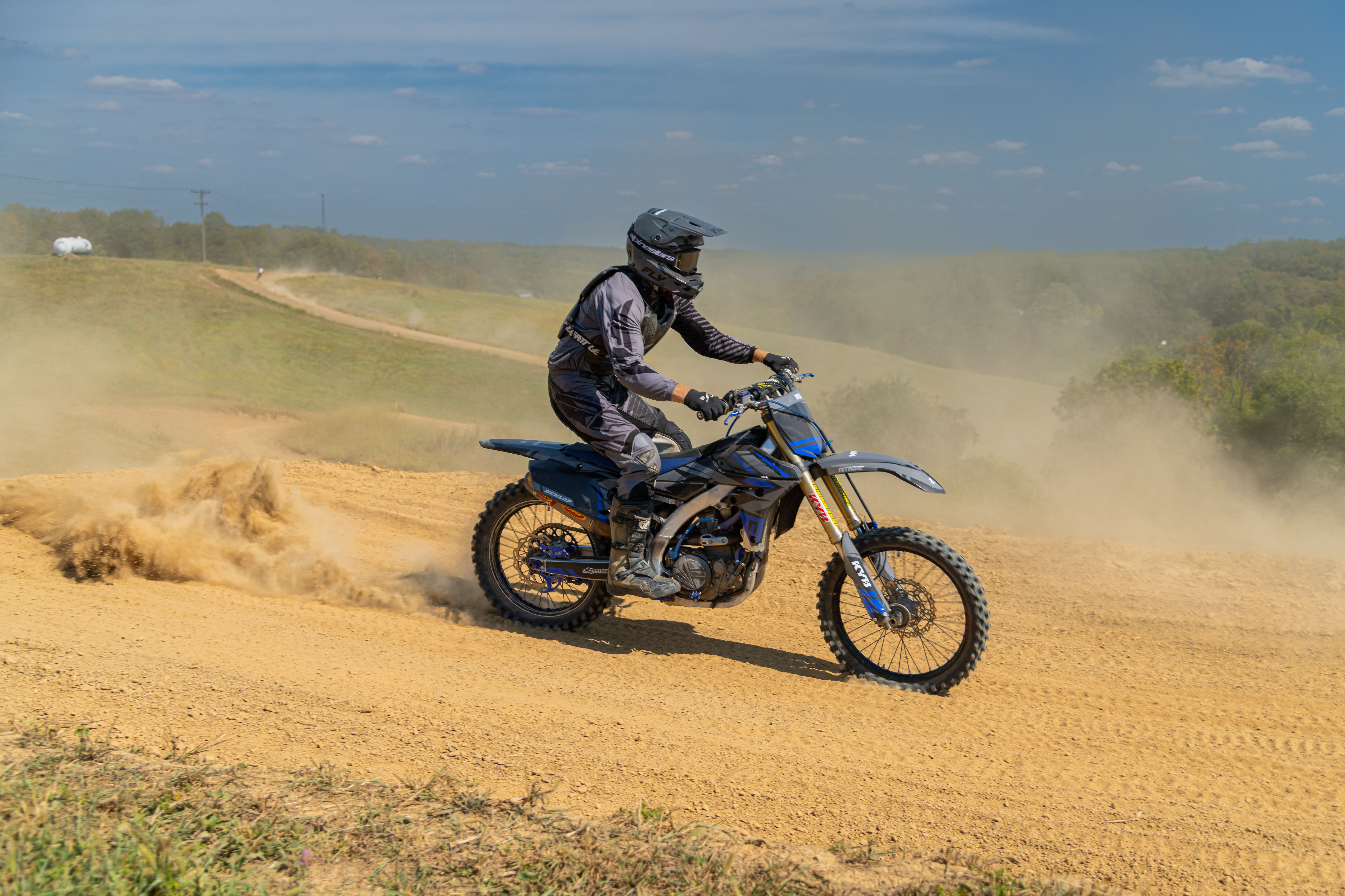 Dirt Bike Rider Kicking Up Dust on Track · Free Stock Photo