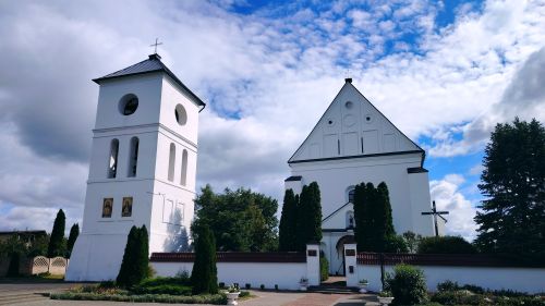 Free Beautiful white church building with bell tower under a vibrant blue sky, showcasing serene architectural design. Stock Photo