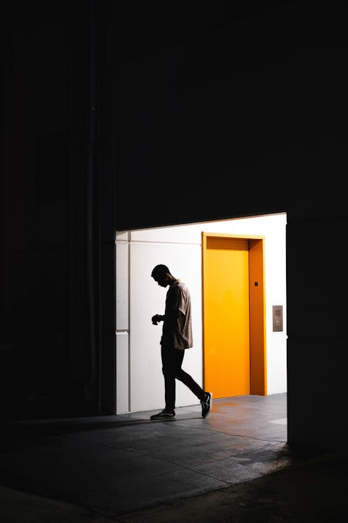 Free Man Entering A Dark Room Stock Photo