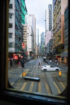 Street view from tram window showcasing intersection and urban architecture.