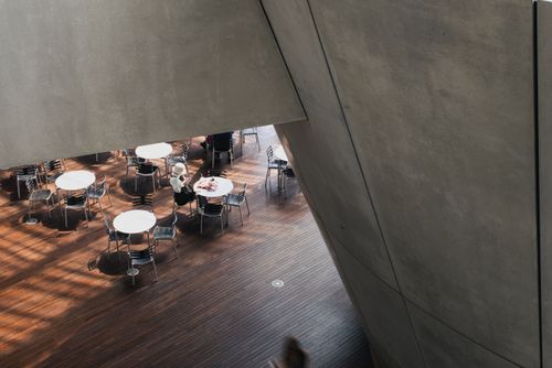 Free High-angle view of a modern indoor cafe with minimalistic tables and chairs. Stock Photo