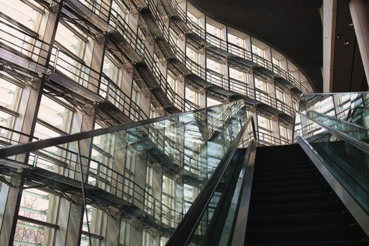 Interior shot of a modern building with glass and steel structures and escalator