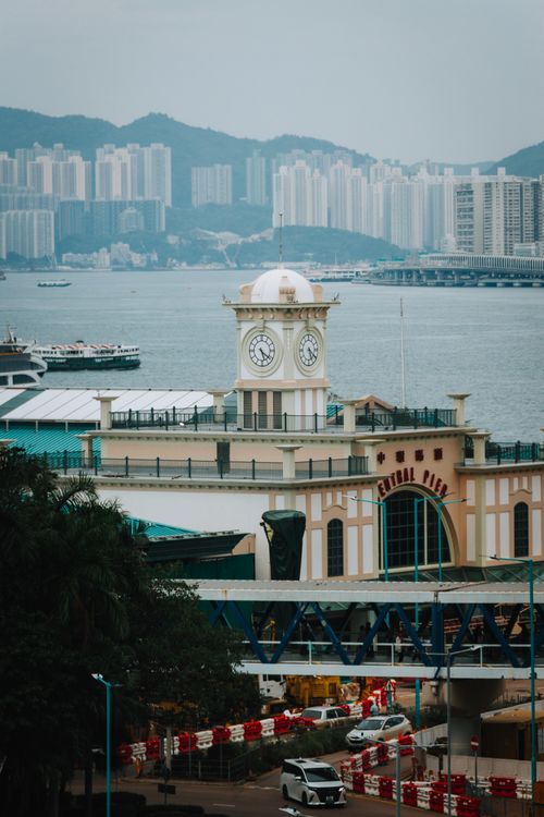 Free Scenic view of the historic Clock Tower at Central Pier with Hong Kong skyline in the background. Stock Photo