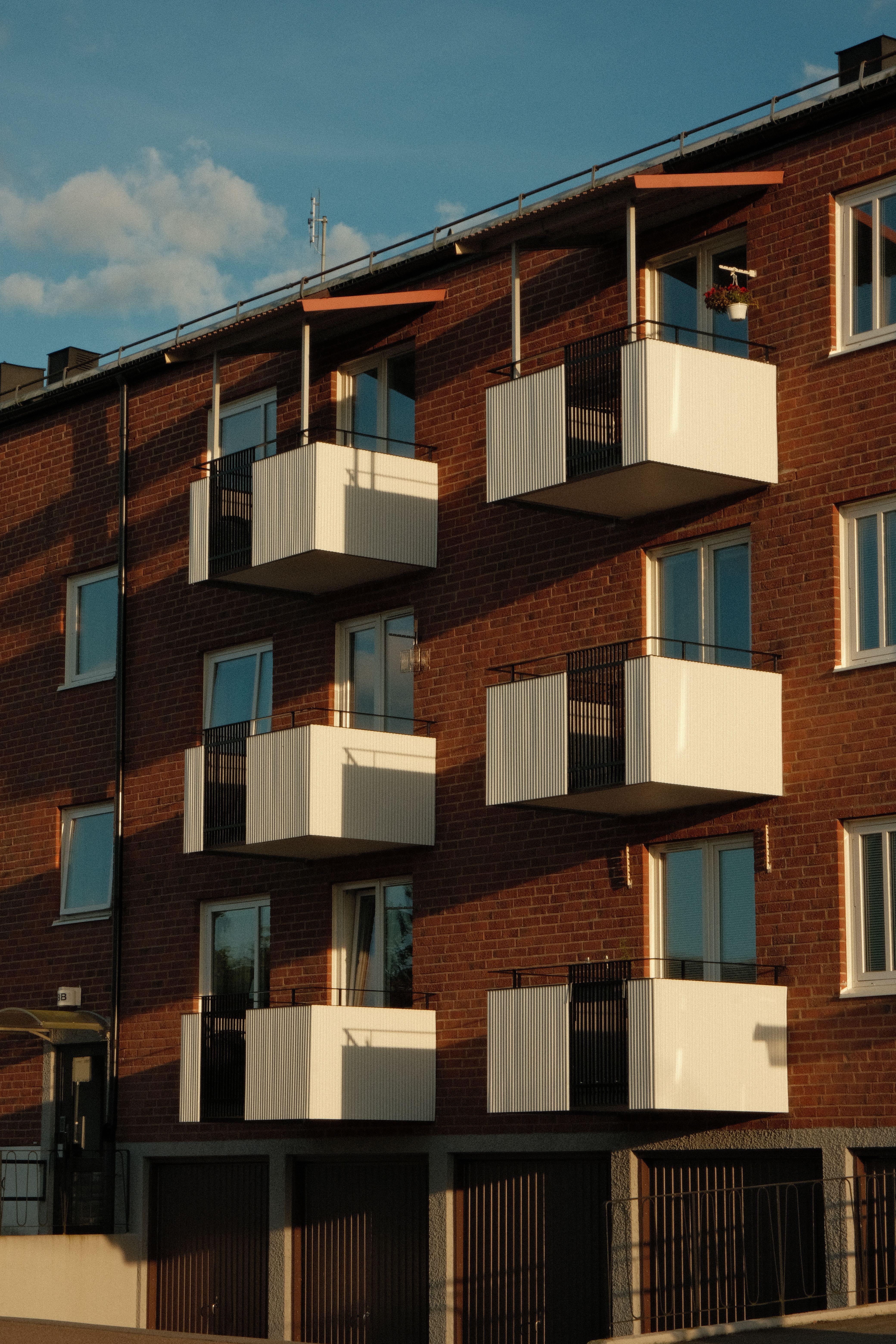 Modern Apartment Building with Balconies at Sunset · Free Stock Photo