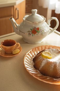 Warm vintage tea time with citrus cake and cup of tea.