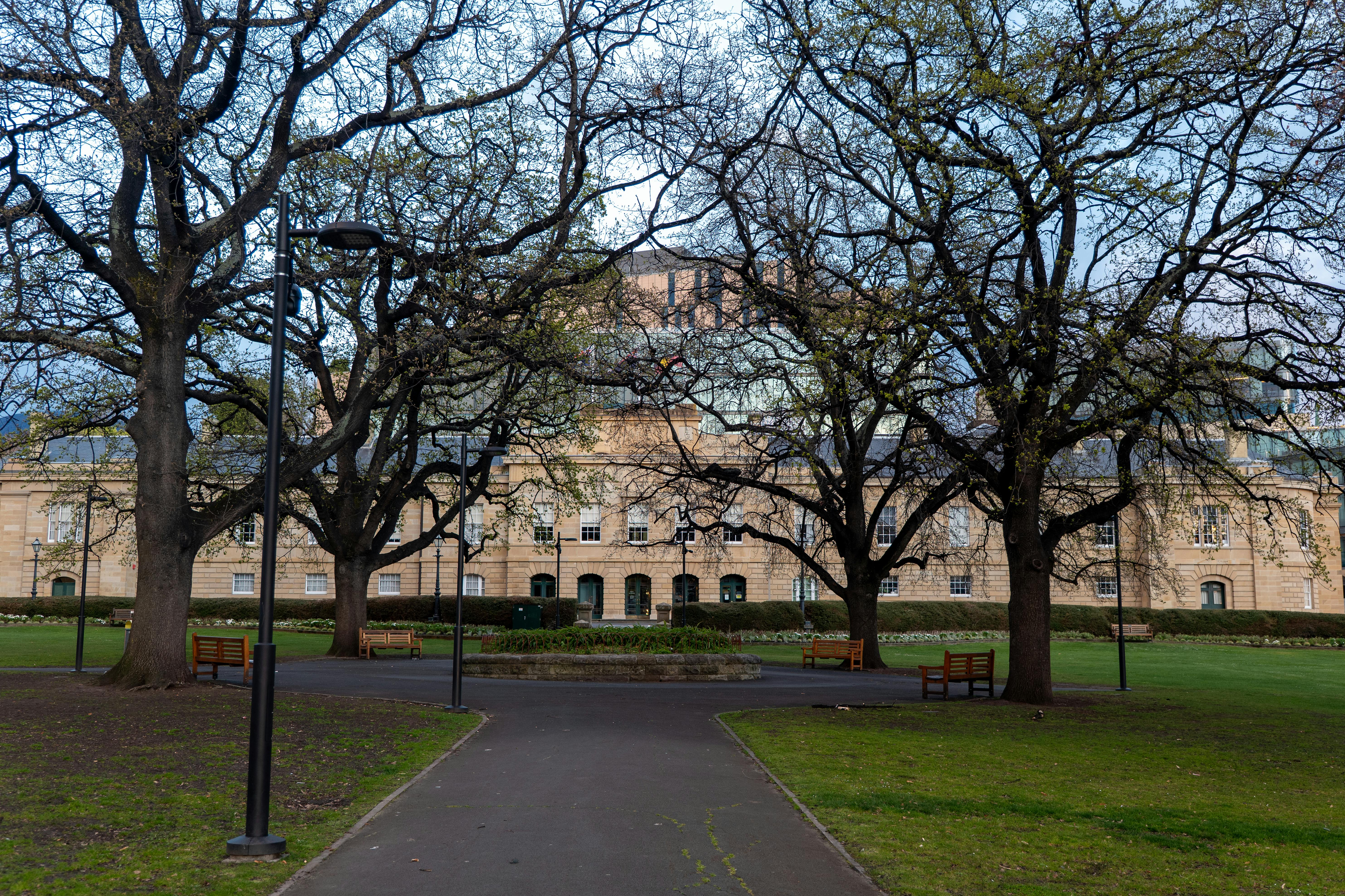 Serene park scene with historic building and trees in Hobart, Tasmania.