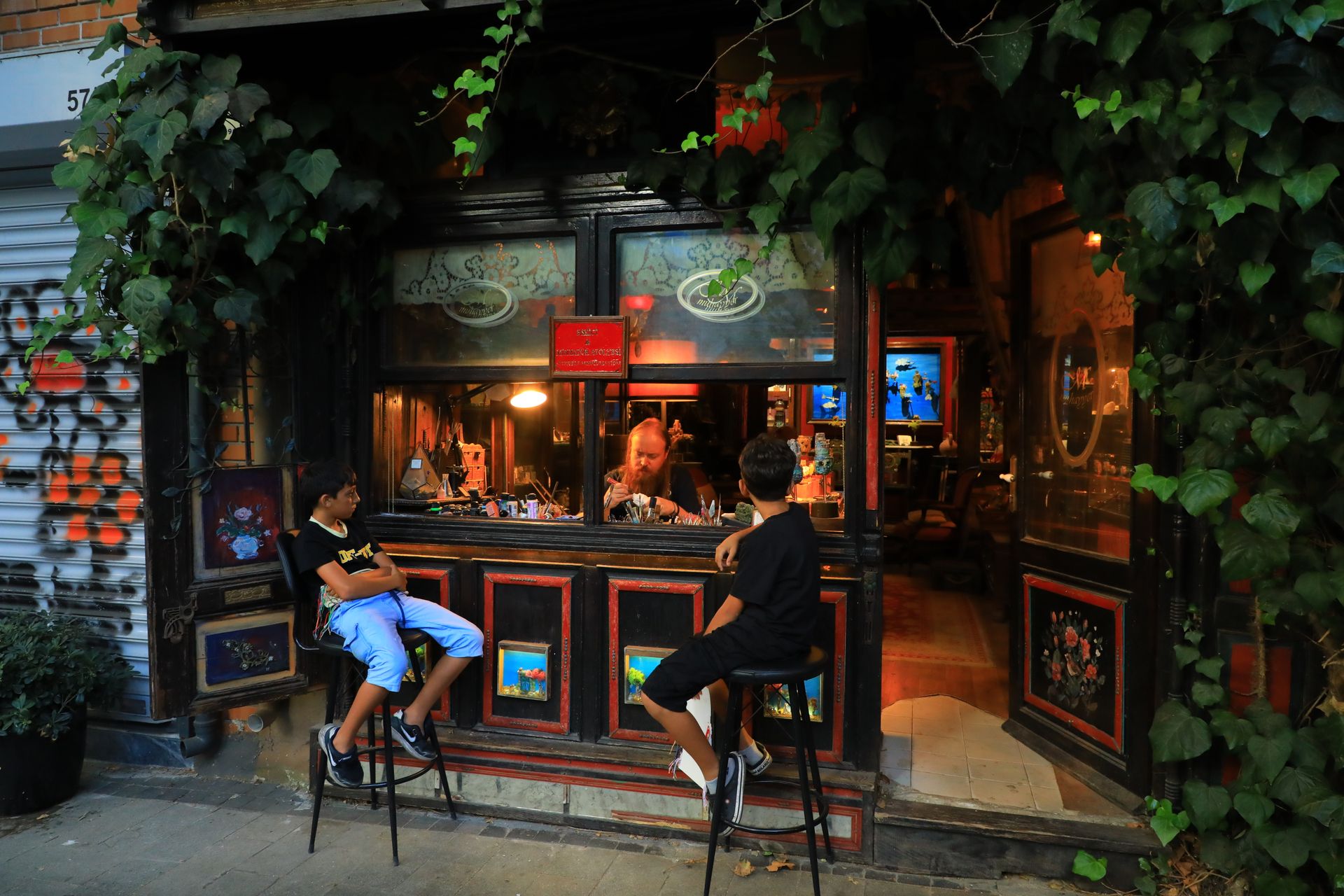 Cozy shop scene in İstanbul featuring kids at dusk, capturing local charm and ambiance.