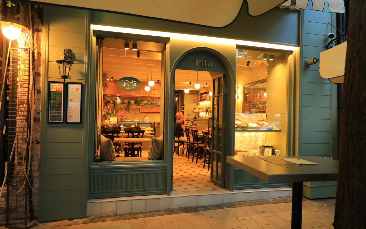 Warm evening shot of a welcoming pita restaurant entrance showcasing a charming atmosphere.