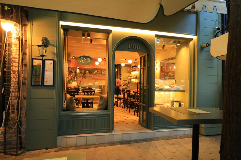 Warm evening shot of a welcoming pita restaurant entrance showcasing a charming atmosphere.